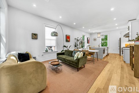 A living room with a green couch and a yellow chair.