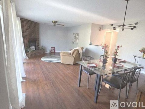 A living room with a glass table and chairs.