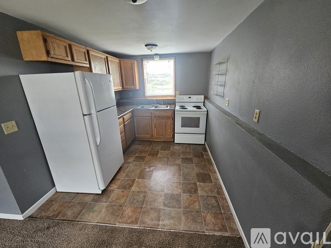 A kitchen with a black stove top oven and white cabinets.