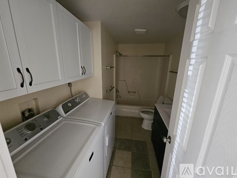 A small laundry room with a washer and dryer.