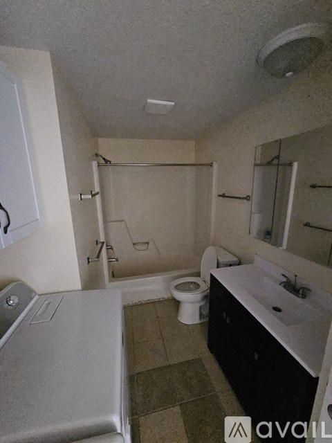 A bathroom with a toilet, sink, and bathtub.