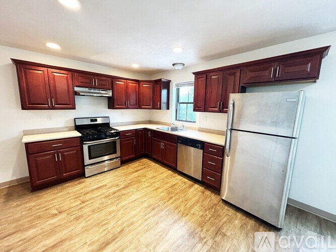 A kitchen with wooden floors and stainless steel appliances.