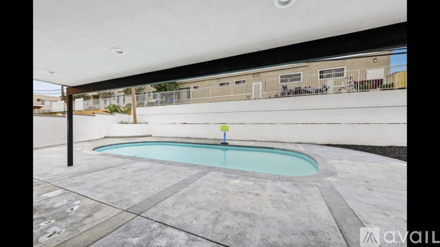 A small pool in a patio with a black pole.