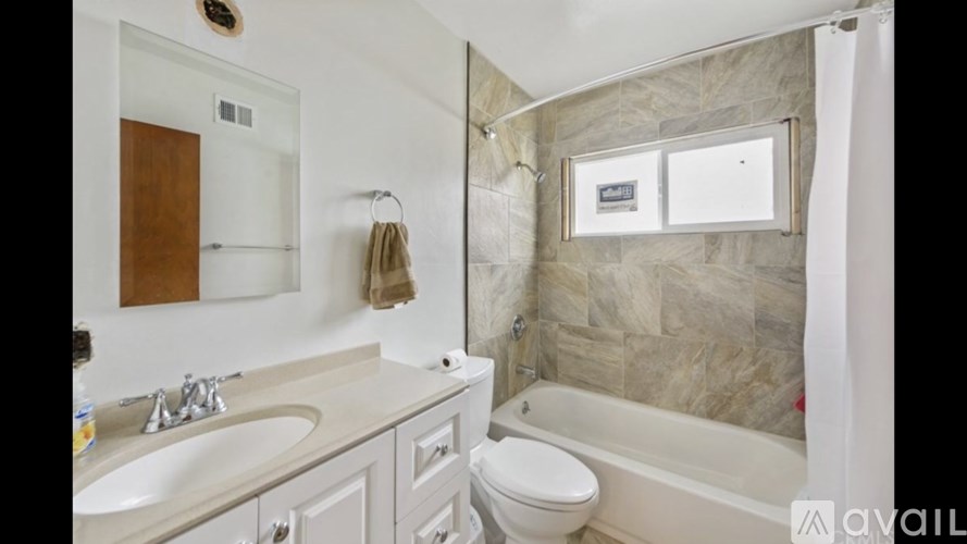 A bathroom with a sink, toilet, and bathtub.
