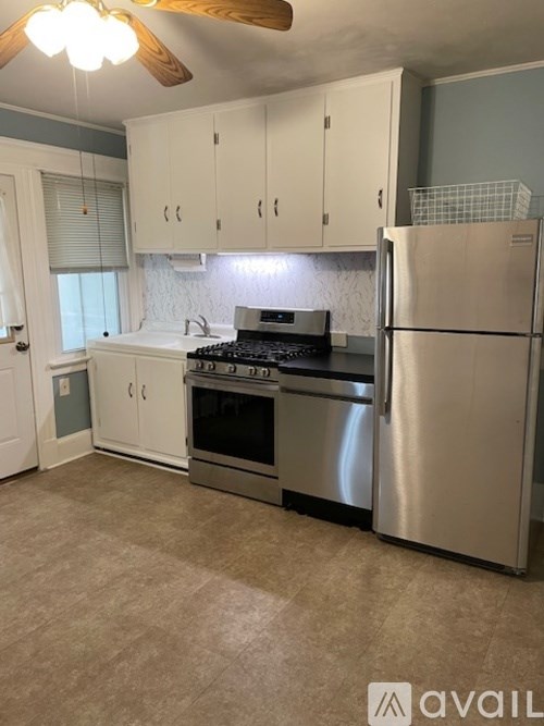 A kitchen with a stove, oven, and refrigerator.