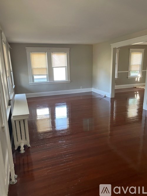 A room with wooden floors and a white radiator.