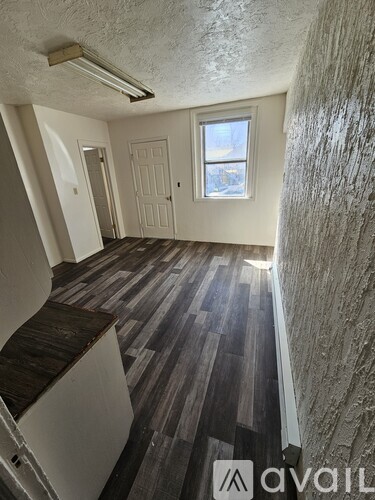 A room with a window and a door.
