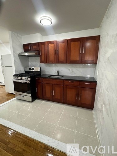 A kitchen with wooden cabinets and a white refrigerator.