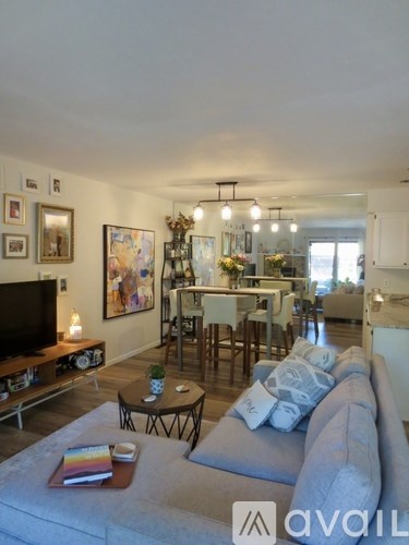 A living room with a grey couch and a television.