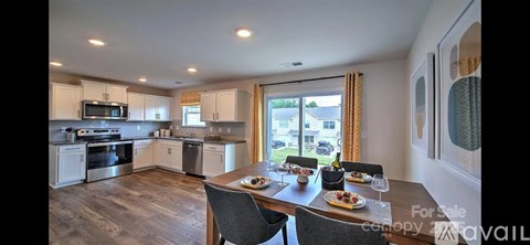 A kitchen with a dining table set for two.