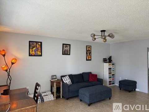A living room with a grey couch and a wooden coffee table.