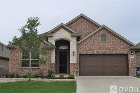 A house with a brick facade and a large garage door.