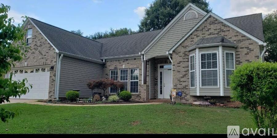 A house with a grey roof and a white garage door.