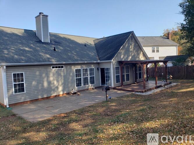 A house with a grey roof and a covered patio area.
