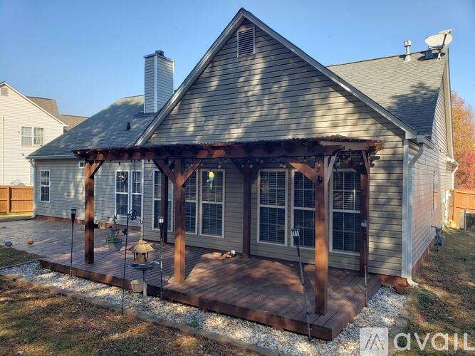 A house with a covered deck and a chimney.