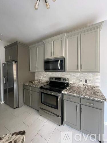 A kitchen with a stove top oven and microwave above it.