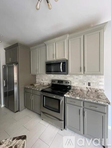 A kitchen with a stove top oven and microwave above it.
