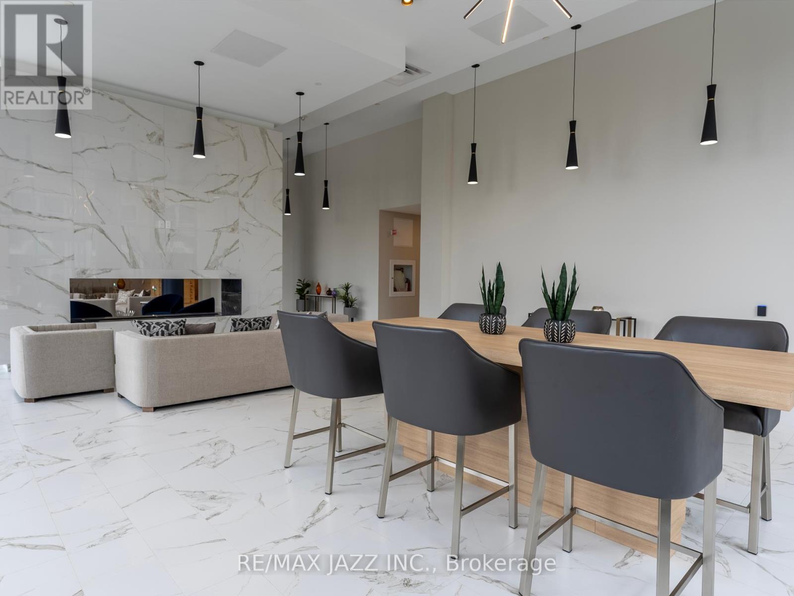 A modern dining room with a marble floor and a large table with chairs.