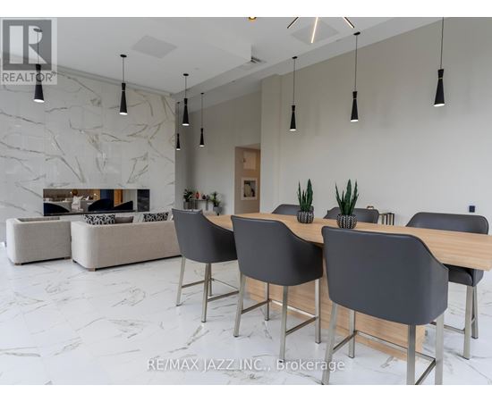 A modern dining room with a marble floor and a large table with chairs.