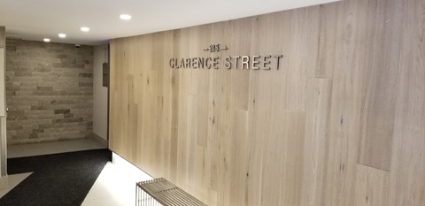 A hallway with a wooden wall and a sign that says Clarence Street.
