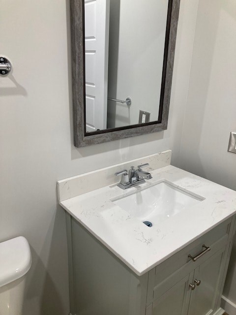 A bathroom with a sink, mirror and toilet.