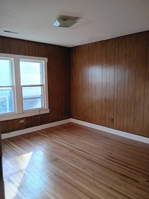 A room with wooden floors and a window.