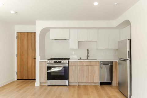 A modern kitchen with wooden cabinets and stainless steel appliances.
