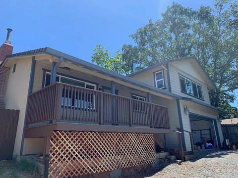 A house with a brown lattice fence in front.