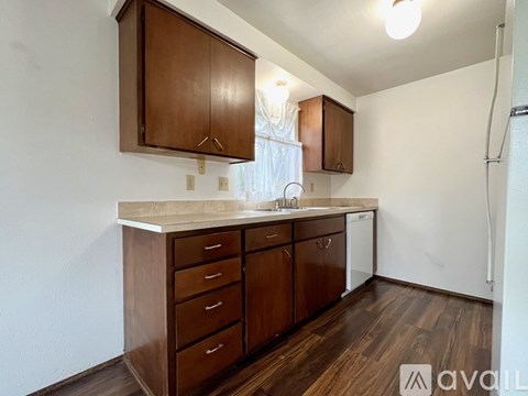 A kitchen with brown cabinets and a white countertop.