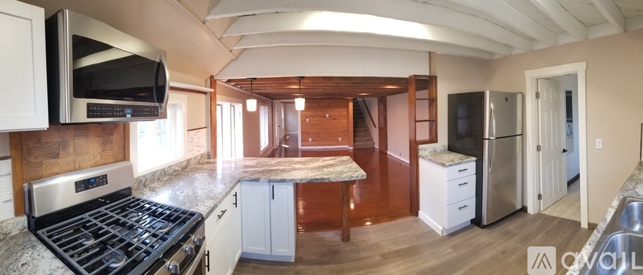 A kitchen with a stove top oven and a refrigerator.