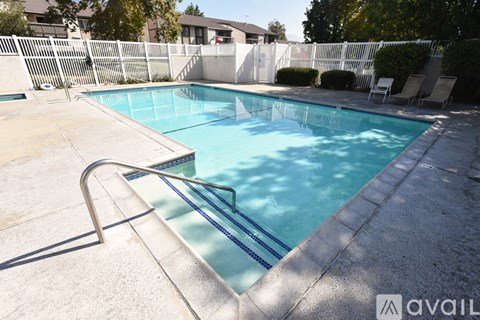 A pool with a slide in the middle of it.