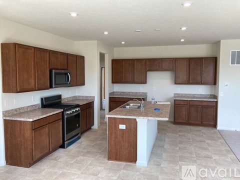 A kitchen with brown cabinets and a white island.