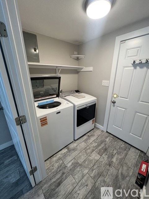 A small kitchen with a white oven and microwave.