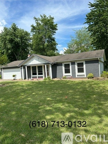 A house with a lawn in front of it and a phone number on it.