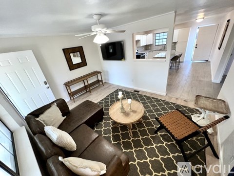 A living room with a brown couch and a coffee table.