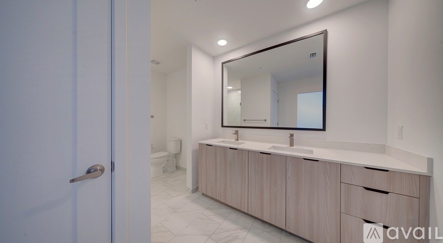 A bathroom with a sink, mirror, and toilet.