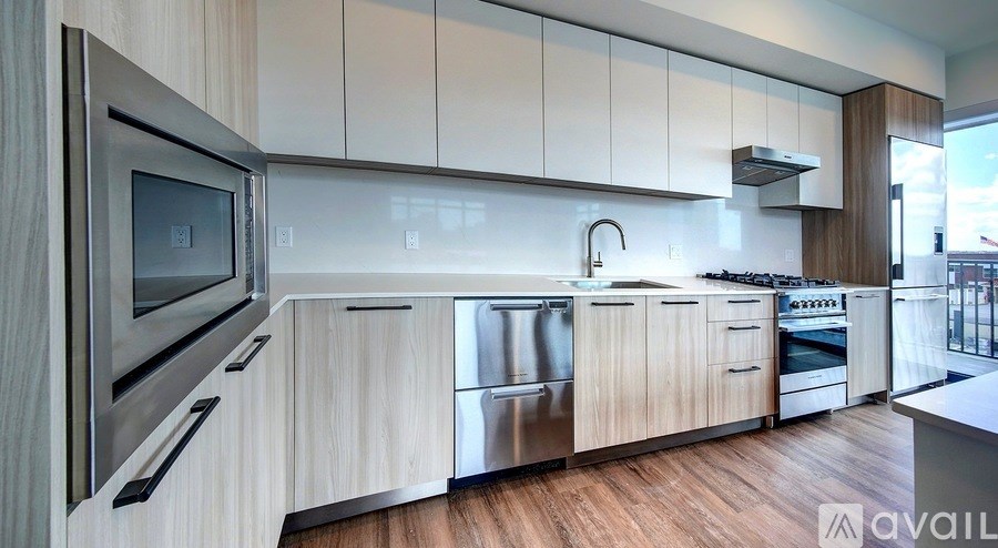 A modern kitchen with wooden cabinets and stainless steel appliances.
