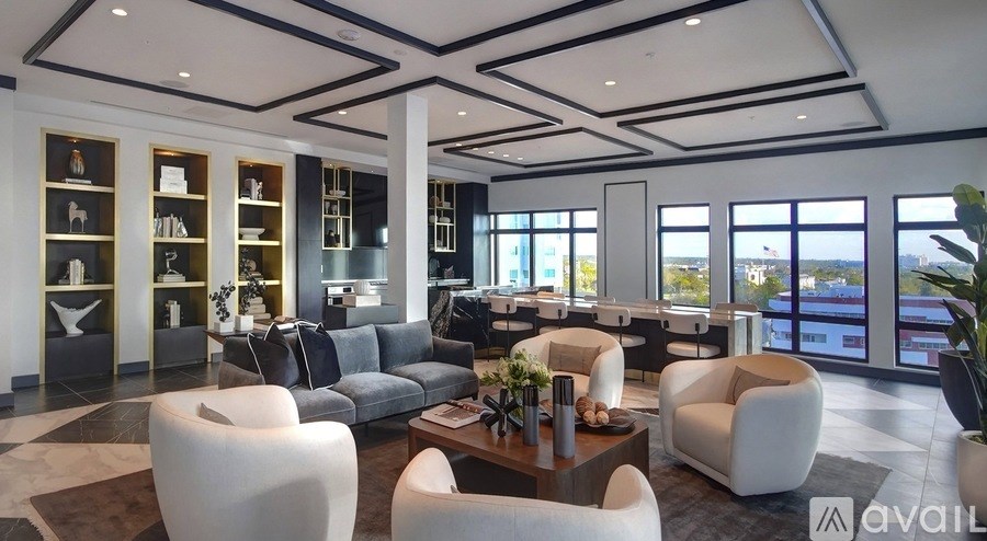 A modern living room with a large window overlooking the city.