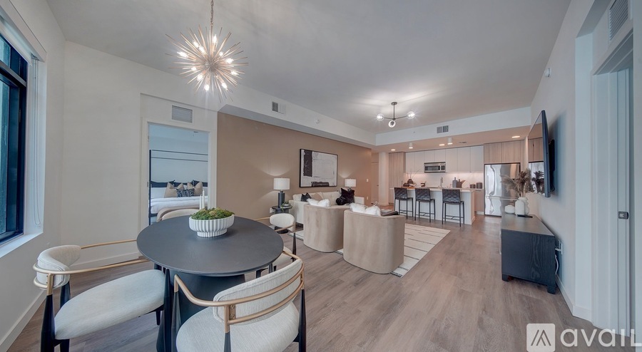 A modern living room with a dining table and chairs.