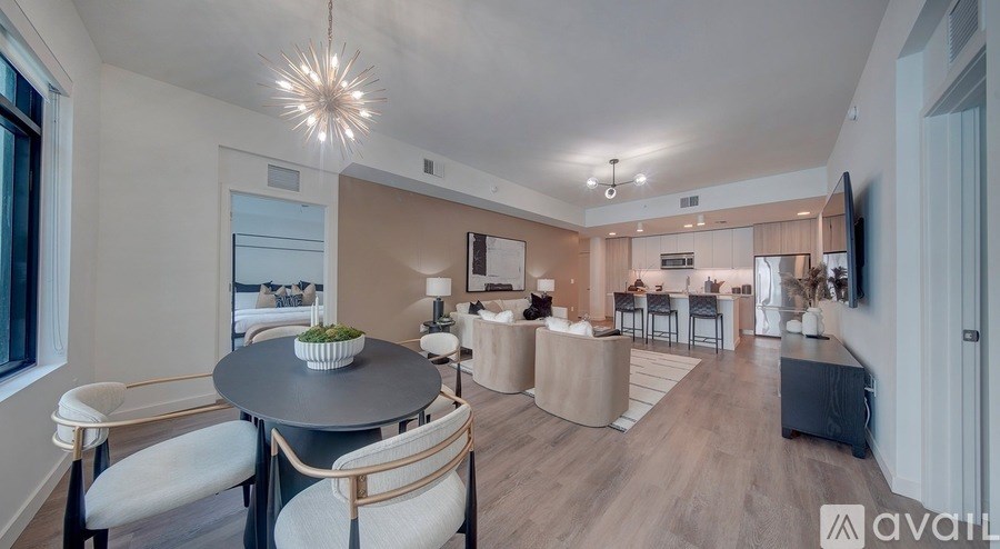 A modern living room with a dining table and chairs.