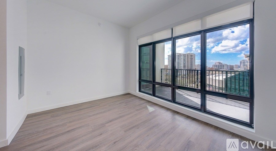A room with a large window overlooking a cityscape.
