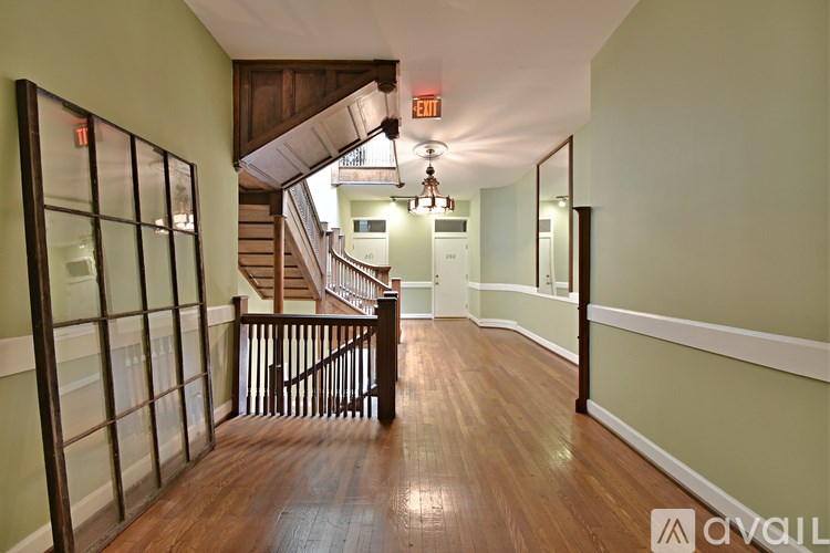 A room with wooden floors and a ceiling fan.