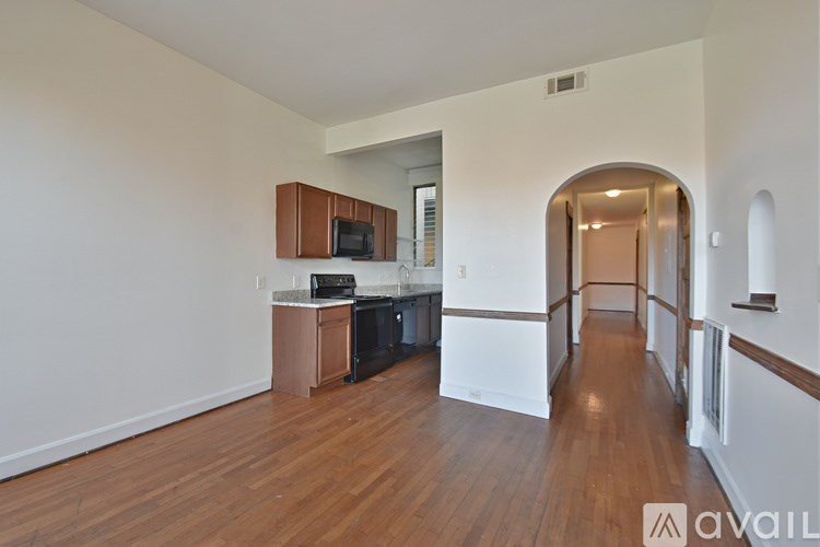 A kitchen area with a microwave, oven, and cabinets.