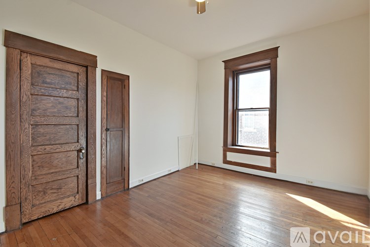 A room with wooden floors and a window with a wooden frame.