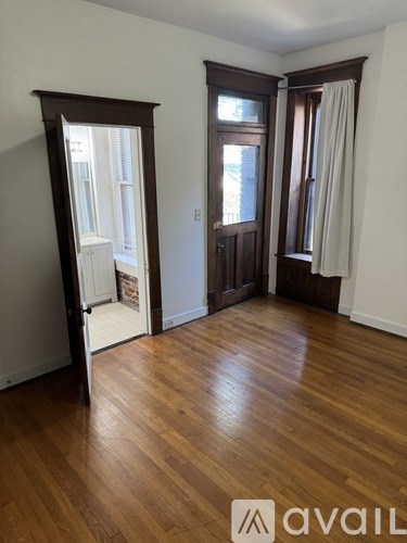A room with wooden floors and white walls.