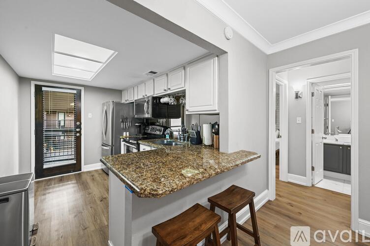 A kitchen with granite countertops and stainless steel appliances.