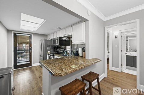 A kitchen with granite countertops and stainless steel appliances.