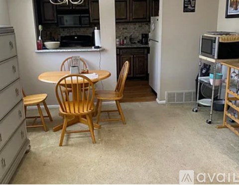 A kitchen with a table and chairs in the middle of the room.