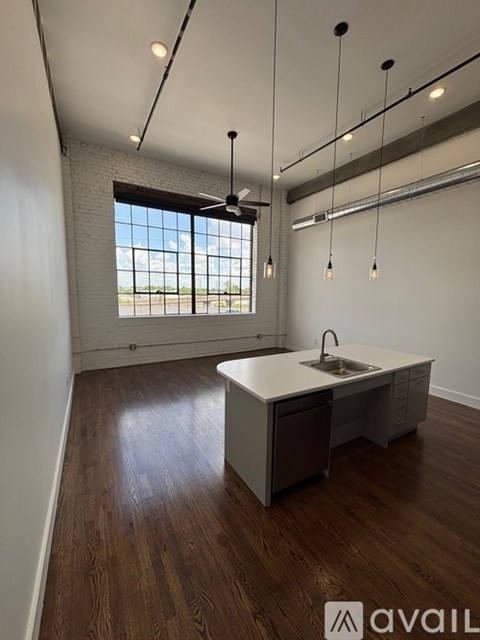 A kitchen with a sink and a window.