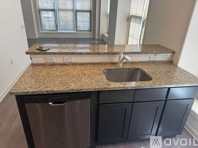 A kitchen counter with a sink and a dishwasher.